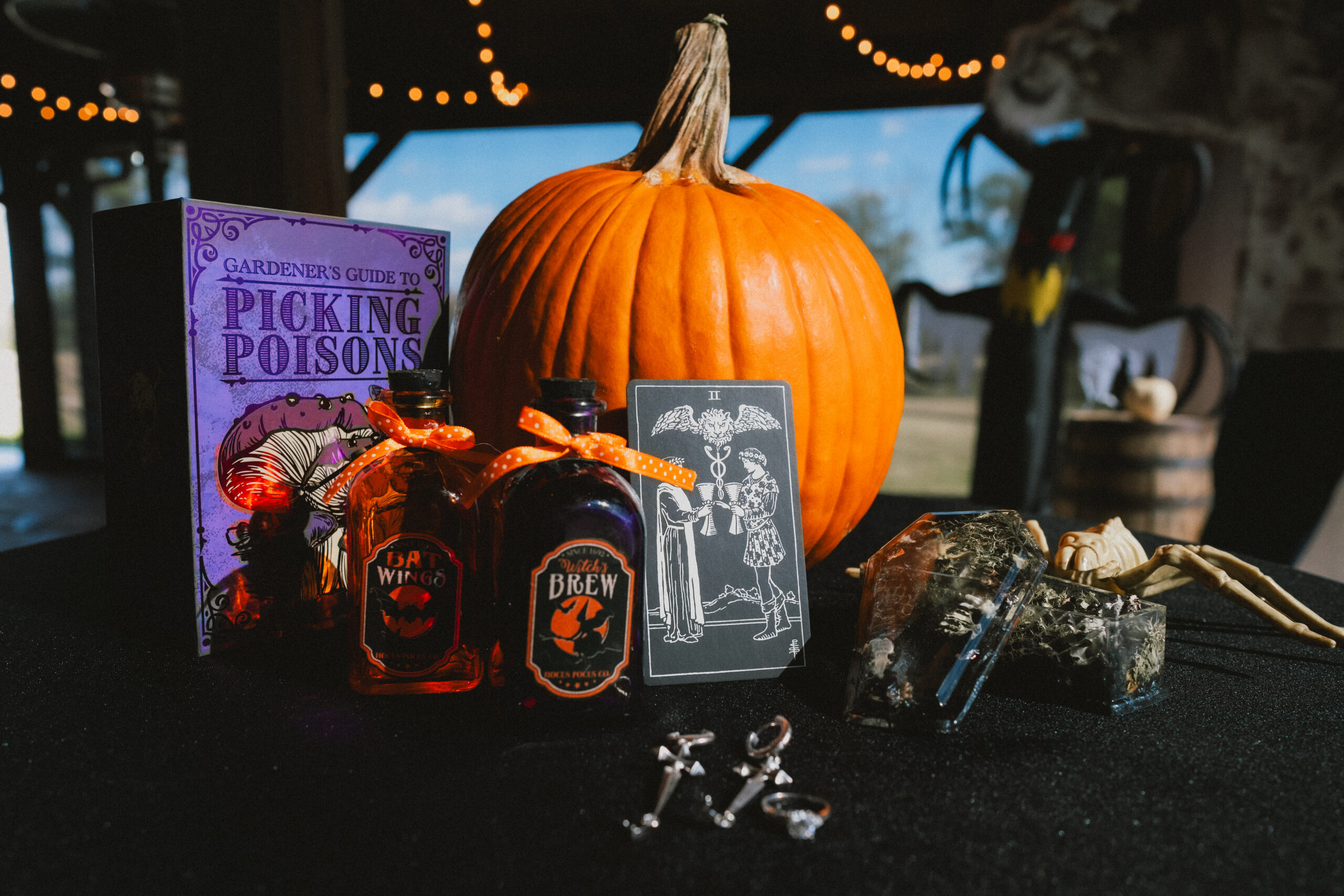 Dagger earrings, Two of Cups tarot, and potion bottles with a pumpkin for Erin & Baxter at Covey Creek