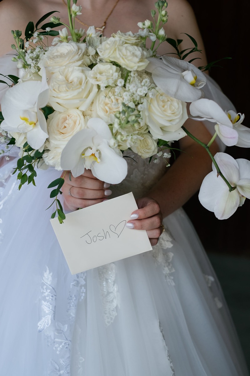 Katelyn & Josh detail: bride’s white orchid-rose bouquet and handwritten Josh note at Covey Creek