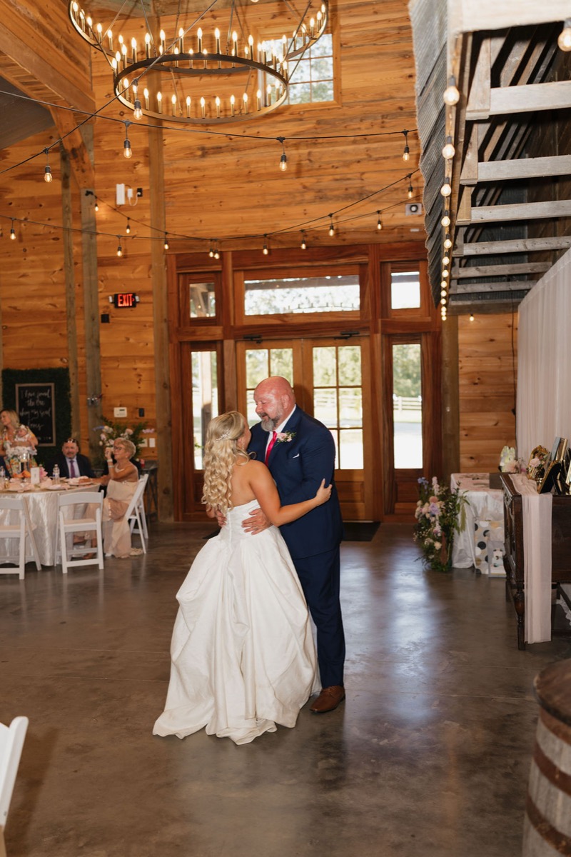 Lilly dances in a strapless gown under a wagon-wheel chandelier at Covey Creek for Lilly & Jackson
