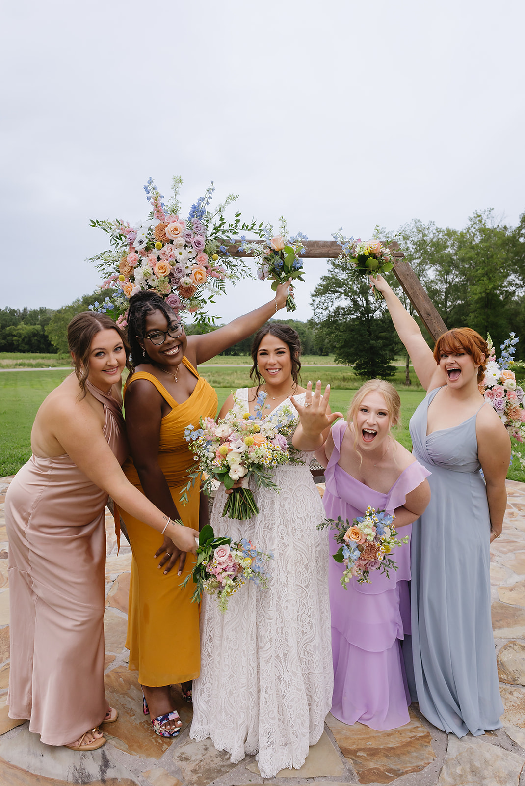Meredith shows her ring as bridesmaids cheer by the Patio arch for Meredith & Benjamin at Covey Creek