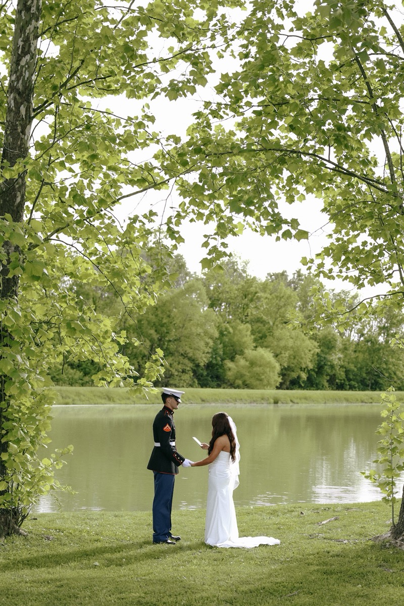 Cadence & Brody exchange vows by the Pond under overhanging leaves in gown and Marine blues at Covey Creek
