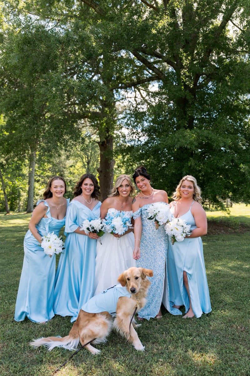 Kyley & Nick's bridal party and golden retriever pose under a large tree on the lawn at Covey Creek
