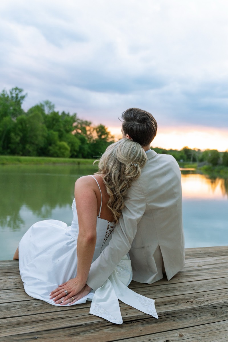 Kyley & Nick watch the Pond sunset as she rests her head on his shoulder at the dock at Covey Creek