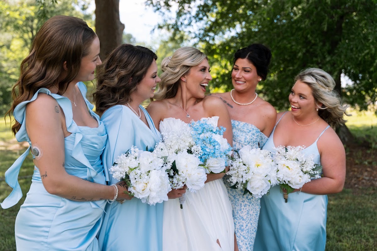 Kyley laughs with bridesmaids in light blue for Kyley & Nick's wedding portraits at Covey Creek