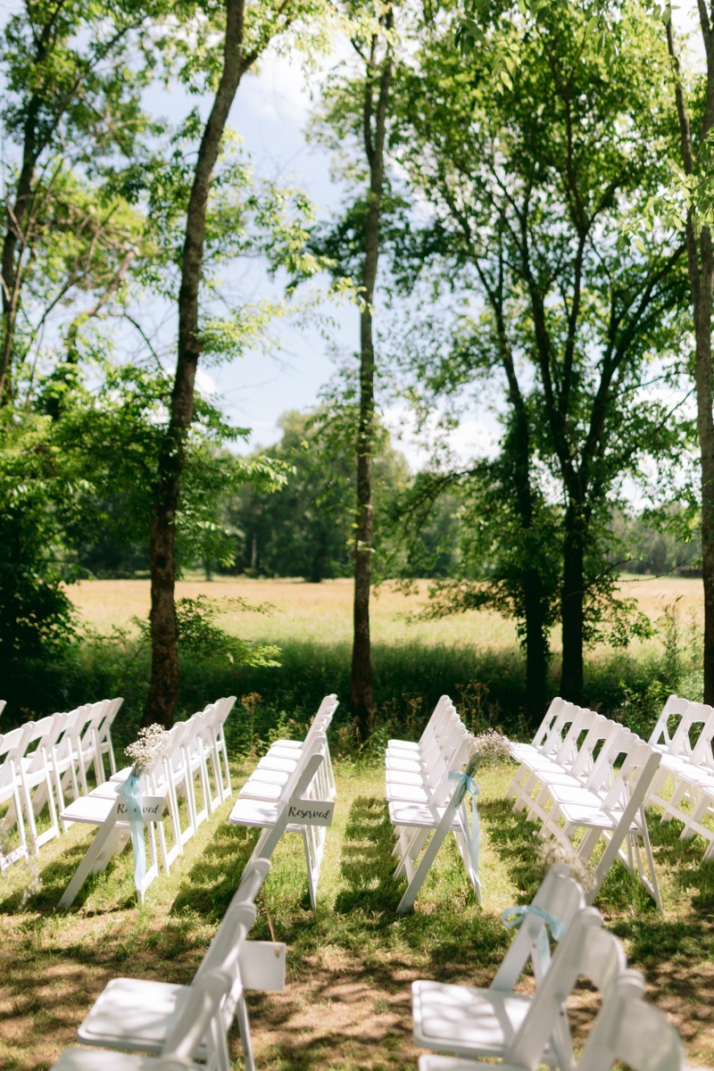 Rachel & Ben ceremony seating under the Tunnel of Love with blue-ribbon florals at Covey Creek.